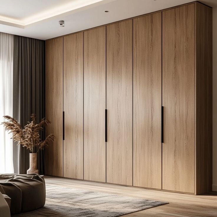 A wardrobe taken all the way up to the ceiling in a small bedroom, maximizing storage without wasting space